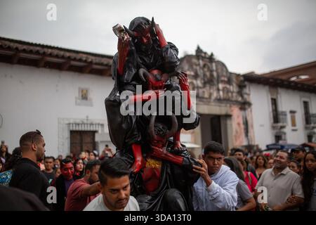 Antigua Guatemala, Guatemala. 08 décembre 2025. Les voisins portent la figure de papier connue sous le nom de « trois diables sages » à brûler, lors de l'incendie du diable à Antigua Guatemala, à la veille de la célébration de la Vierge de l'Immaculée conception, festivités qui marquent le début de Noël. Crédit : SOPA images Limited/Alamy Live News Banque D'Images