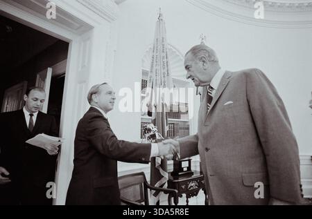 Le Dr E. C. Welsh serre la main du président Lyndon B. Johnson. Banque D'Images