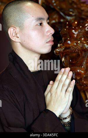 Truc Lam Chanh Giac Zen Monastère. Moine bouddhiste priant avec les mains serrées. Cai Lay. Vietnam. Banque D'Images
