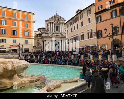 Les visiteurs se rassemblent autour de la fontaine de Trevi à Rome, en Italie, pour admirer les sculptures baroques spectaculaires et les chutes d’eau de l’une des fontaines les plus célèbres et emblématiques du monde le 19 novembre 2019 Banque D'Images