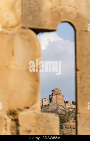 Le monastère de Djvari à Mtskheta, en Géorgie, capturé par une ancienne arche en pierre, présente son architecture historique sur fond de cercle Banque D'Images