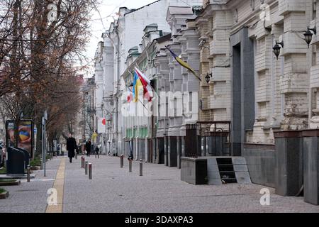 Drapeaux de différentes Nations balancent doucement sur une rue sereine de la ville en hiver. Kiev, Ukraine. 12 décembre 2025. Banque D'Images