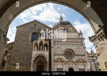 Chapelle Renaissance Colleoni à Città Alta, Bergame, montrant une façade en marbre polychrome et un dôme encadrés par une arche en pierre. Banque D'Images
