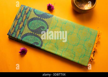 Saree de coton plié de l'érode, Tamil Nadu, Inde sur fond jaune Banque D'Images