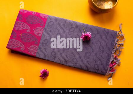Saree de coton plié de l'érode, Tamil Nadu, Inde sur fond jaune Banque D'Images