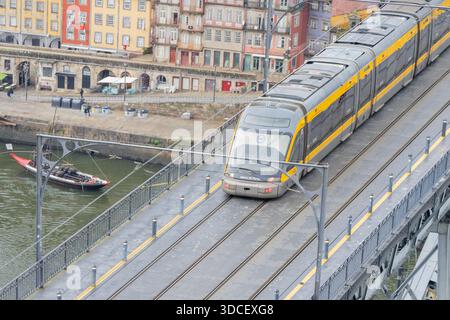 Tramway du métro de Porto traversant l'emblématique pont dom luis i reliant porto et vila nova de gaia Banque D'Images