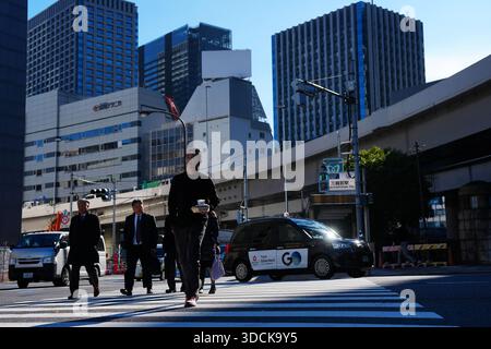 (251219) -- TOKYO, Dec. 19, 2025 (Xinhua) -- les piétons traversent une route à Tokyo, Japon, Dec. 18, 2025. La Banque du Japon (BOJ) a relevé vendredi son taux d'intérêt de référence de 25 points de base à 0,75 %, son plus haut niveau depuis trois décennies, après une réunion de politique monétaire de deux jours. (Xinhua/Jia Haocheng) Banque D'Images