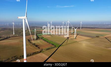 La turbine éolienne aérienne projette de l'ombre sur les champs agricoles Banque D'Images