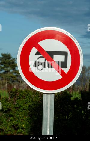 Un panneau routier rond interdit les camping-cars. Le panneau est blanc avec une bordure rouge et une diagonale rouge à travers le symbole du camping-car en France. Banque D'Images