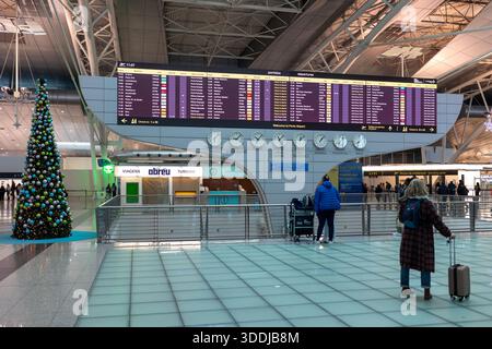 Un tableau numérique des départs indique les retards et les changements de porte d'embarquement pendant les perturbations nationales des voyages à l'aéroport de Porto. 01 janvier 2026 Banque D'Images