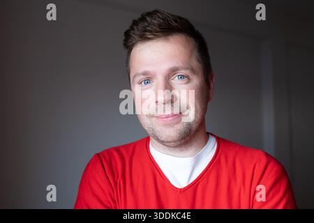 Portrait d'un homme européen d'âge moyen dans un pull rouge, photographie émotionnelle Banque D'Images