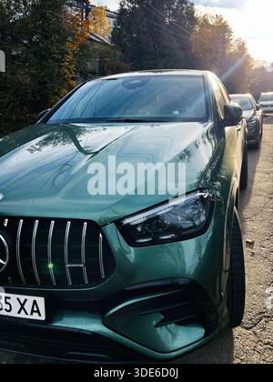 Lviv, Ukraine - 03 novembre 2025 : un VUS Mercedes-Benz classe GLE vert coupé dans une rue calme, la lumière automnale étincelant sur le chrome et le verre élégants. Banque D'Images
