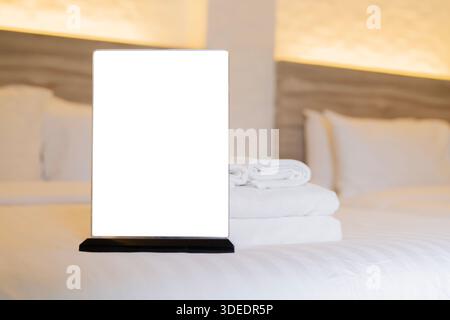 Panneau blanc carton avec espace de copie sur la chambre d'hôtel. Intérieur de l'hôtel. Carte blanche vide sur un porte-carte dans une chambre d'hôtel Banque D'Images
