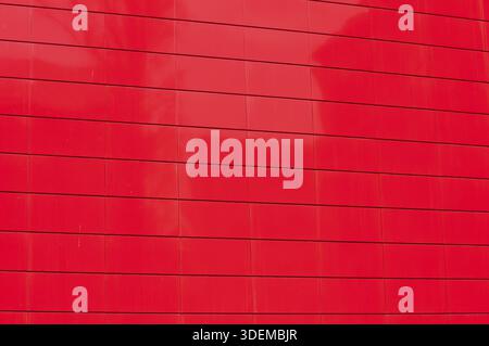 Mur de panneau en métal rouge de façade de construction de bureau contemporain closeup comme arrière-plan Banque D'Images