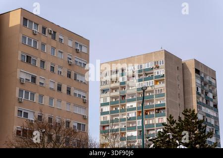 Deux bâtiments résidentiels sont présents dans une zone urbaine. Un bâtiment a de nombreuses fenêtres et balcons, tandis que l'autre affiche un design plus simple. Canette à neige Banque D'Images