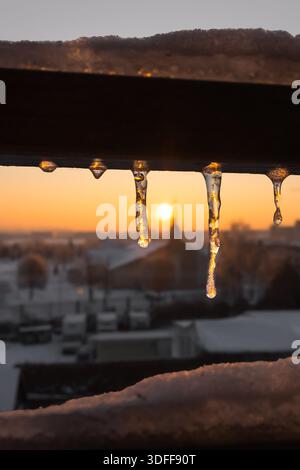 Aube hivernale. Icicle dans les rayons du soleil du matin. Paysage urbain. Temps froid. Matin glacé. Eau dure. Motifs de glace. Beauté de la nature. Banque D'Images