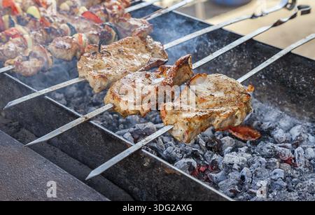 Pièces d'appétissants juteux des grillades de viande cuite sur le grill sur la braise Banque D'Images