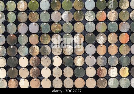 Arrière-plan de petites plaques de métal de couleur or. Fond doré de disques d'or ronde chaotiquement tourne dans le vent Banque D'Images