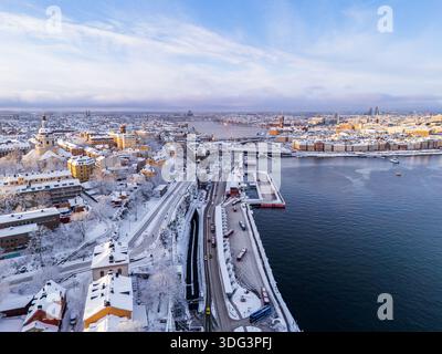 Vue aérienne sur la côte enneigée de Södermalm avec vue sur Slussen et l'architecture de la vieille ville de Gamla Stan à Stockholm, Suède Banque D'Images