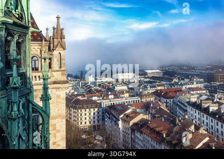 Vue surélevée depuis la cathédrale Saint-Pierre de Genève, en Suisse, sur les gratte-ciel de la ville pendant une journée d'hiver brumeuse avec le soleil Banque D'Images