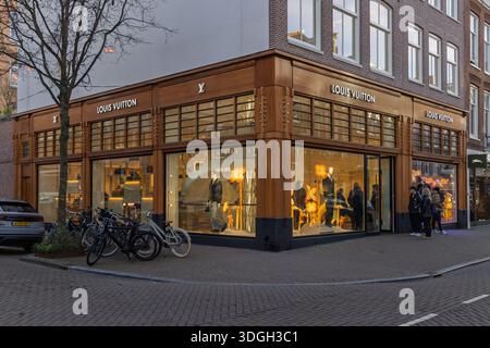 Extérieur du magasin de mode de luxe Louis Vuitton sur P.C. Hooftstraat avec vélos stationnés et grandes vitrines lumineuses. Amsterdam pays-Bas, Banque D'Images