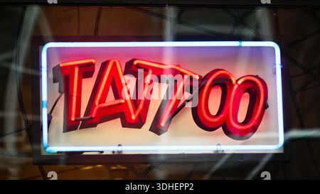 New York, NY - 28 décembre 2025 : signe coloré de TATOUAGE au néon dans la fenêtre du studio de tatouage Banque D'Images