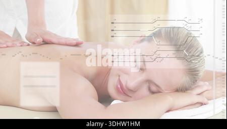 Recevoir femme couchée face vers le bas sur la table de massage, thérapeute plaçant les mains, serviette blanche, superposition Banque D'Images
