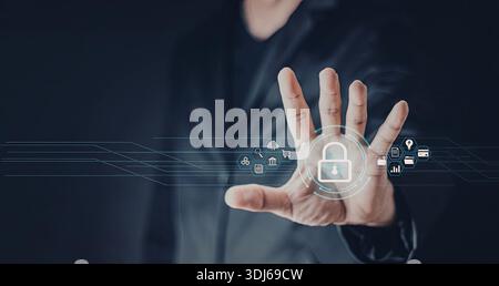 Image en gros plan d'une main interagissant avec une interface numérique affichant diverses icônes de sécurité. La main est positionnée sur une icône de cadenas, suggérer Banque D'Images
