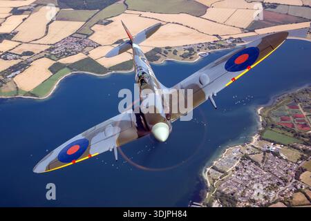 Gros plan air-air d'une variante Seafire Supermarine Spitfire LF Mk Vc construite par Westland et volée à UK Warbirds 2022. Immatriculé G-IBSY, l'avion porte les marquages d'affichage de la Royal Air Force et le code DV-V. Il est propulsé par un moteur à pistons Rolls-Royce Merlin 45 V-12. L'image montre la verrière encadrée, les ailes elliptiques, le capot moteur, les cheminées d'échappement et les détails de la cellule Spitfire du début de la guerre conservés pour les expositions de vol historiques. Banque D'Images