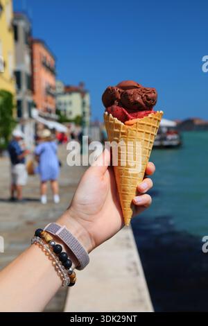 Glace à Venise, Italie. Main tenant la glace à glace italienne dans le cône. Banque D'Images