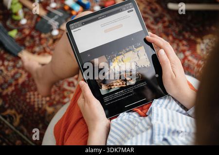 Paris, France - 11 juin 2023 : mains tenant l'iPad affichant le contenu visionOS et Apple Arcade lors du lancement de Vision Pro dans le salon Banque D'Images