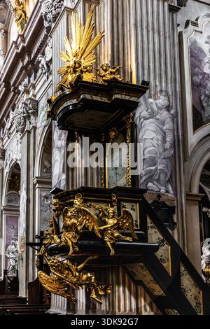 Chaire richement décorée avec des sculptures dorées complexes, ange sur la chaire a une signification symbolique et sert de figure annonciatrice, par Antoni FrCcki Banque D'Images