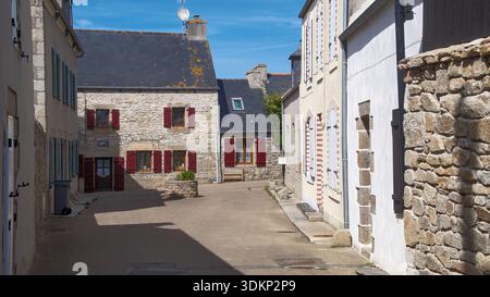 Une charmante vue sur le village avec des maisons traditionnelles en pierre avec des volets rouges vibrants, dans un cadre rural paisible. Banque D'Images
