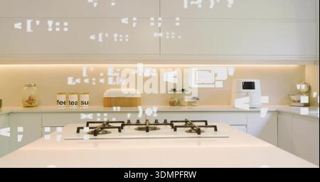 Affichage îlot blanc avec table de cuisson à gaz intégrée dans la cuisine moderne, avec des bidons étiquetés Banque D'Images