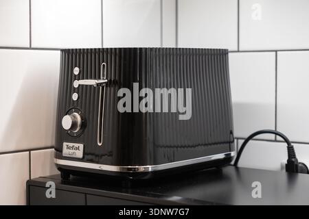 Cracovie, Pologne - 30 novembre 2025 : gros plan d'un grille-pain de cuisine noir contemporain avec une surface nervurée élégante et des accents argentés polis, Banque D'Images