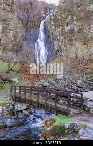 Passerelle en bois au-dessus de la rivière sous les chutes Aber ou la cascade Rhaeadr Fawr dans la réserve naturelle nationale Coedydd Aber dans le parc national de Snowdonia. Pays de Galles, Royaume-Uni Banque D'Images