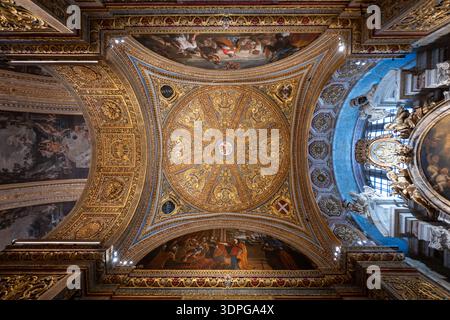Valletta, Malte - 13 août 2025 : regardant vers le haut le plafond baroque doré et les panneaux peints à l'intérieur de la Co-cathédrale Johns à la Valette, Malte, avec orne Banque D'Images