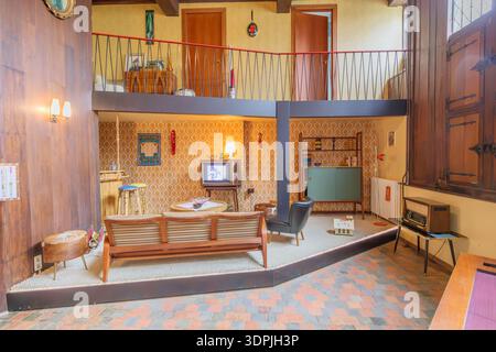 Genk, Belgique. 17 octobre 2025. Intérieur d'une maison des années 1960 salon, deux étages avec décor d'époque, canapé, télévision, radio, bar avec tabourets hauts, s. Banque D'Images