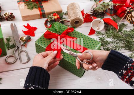 Préparer des boîtes cadeaux avec des rubans et des décorations pour une célébration festive Banque D'Images