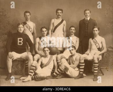Cette photographie capture l'équipe de basket-ball de l'Université Brown 1901-1902, montrant les membres de l'équipe Leland, Ingalls, Roy, Smith, Schwinn, Manderville et DeWolf. L'image, prise par Sands & Brady, est un portrait de groupe posé probablement utilisé pour les archives et la documentation historique. Les joueurs sont disposés en ligne, portant des uniformes d'athlétisme du début du XXe siècle. La photographie fournit des preuves visuelles de l'histoire du basket-ball universitaire, de la composition de l'équipe et des tenues sportives au cours de l'année scolaire 1901-1902 à l'Université Brown. Banque D'Images