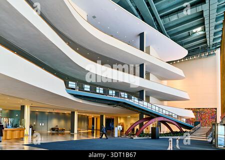 Les gens se déplacent par l'entrée du Siège des Nations Unies à Manhattan. Le bâtiment montre une architecture et un design modernes. Banque D'Images