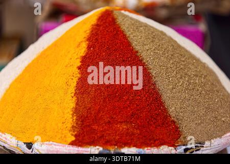 155 mélange d'épices marocaines traditionnelles, ras el hanout (''tête de la boutique''), dans une pyramide colorée à un étal du marché central. Rissani-Maroc. Banque D'Images