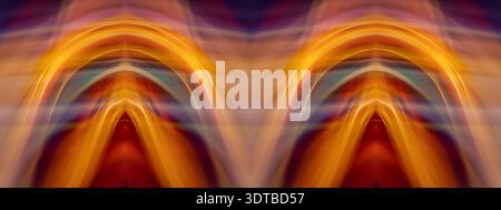 Une œuvre d'art abstrait numérique présentant des traînées lumineuses jaunes et oranges qui se chevauchent et forment des lignes fluides et courbes contre un arrière-plan sombre et flou Banque D'Images