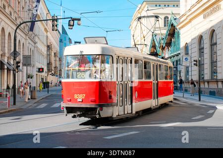 PRAGUE, RÉPUBLIQUE TCHÈQUE - 12 AOÛT 2024 : un tramway rouge traditionnel numéro 26 parcourt une rue historique bordée de bâtiments classiques dans le centre Banque D'Images