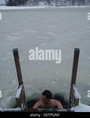 Homme calmement assis dans l'eau glacée à Stockholm Suède Banque D'Images
