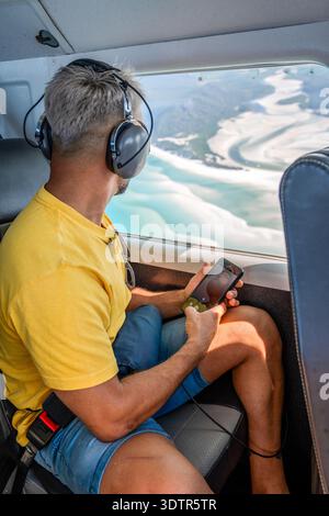 Personne observant les îles pittoresques des whitsunday depuis la fenêtre de l'avion Banque D'Images