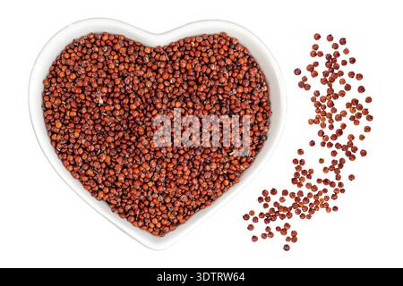 graines de quinoa rouge dans un bol en céramique comme fond. Vue de dessus. Pose à plat Banque D'Images