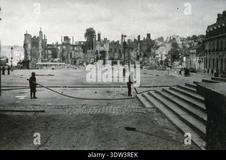 Civils dans la ville dévastée de Lisieux après le raid aérien allié du 6 juin 1944. Le 6 juin 1944, une énorme force d'invasion Alllied impliquant 7000 navires et 140 000 hommes débarque avec succès sur les côtes françaises et établit cinq têtes de plage. Une campagne de tromperie réussie signifiait qu'une grande partie de la résistance allemande était à Calais et que les pertes étaient relativement peu nombreuses compte tenu de l'ampleur et des dangers de l'opération. De nombreuses villes françaises historiques ont été détruites avant et pendant les débarquements. Banque D'Images