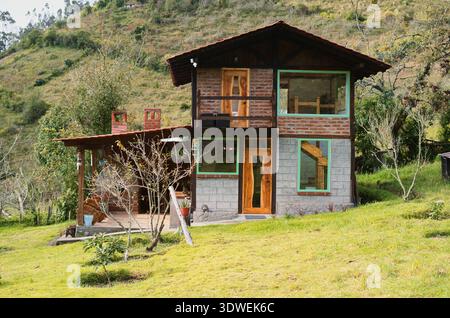 Belle cabane rustique mêlant architecture moderne et traditionnelle, avec briques apparentes, blocs de béton et grandes fenêtres offrant une vie magnifique Banque D'Images