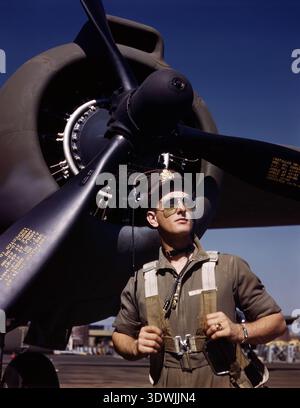 Le lieutenant Mike Hunter, pilote d'essai de la Douglas Aircraft Company, se tient fièrement devant un bombardier bimoteur Douglas A-20 Havoc en octobre 1942. Cette photographie vintage saisissante capture un moment de dévouement en temps de guerre, mettant en vedette le pilote dans son uniforme de vol avec des lunettes de soleil, regardant au loin. Banque D'Images